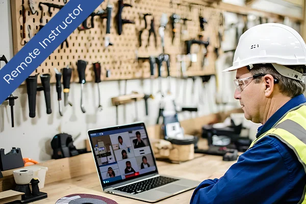 A construction worker wearing a hard hat and safety vest uses a laptop for remote training in a workshop. The scene emphasizes on-the-job learning and continuous safety education.