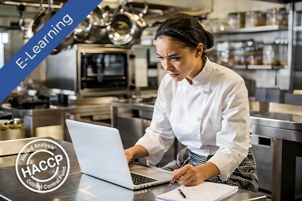 A chef using a laptop in a modern kitchen with HACCP and E-Learning logos for food safety training.